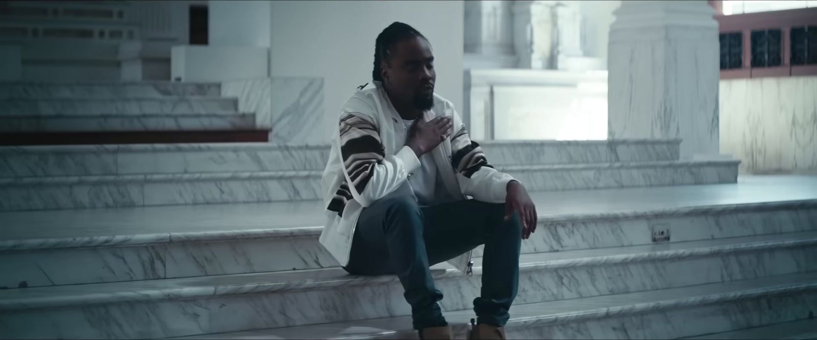 a man sitting on the steps of a building