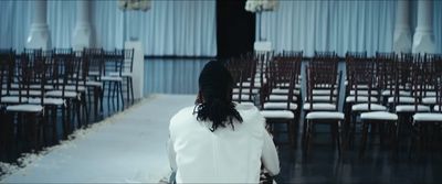 a woman standing in front of rows of chairs