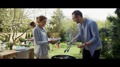 a man and a woman are cooking outside