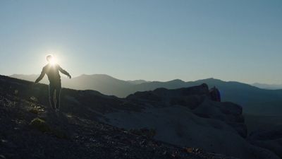 a man riding a bike down a rocky hillside