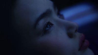 a close up of a woman's face with blue eyes