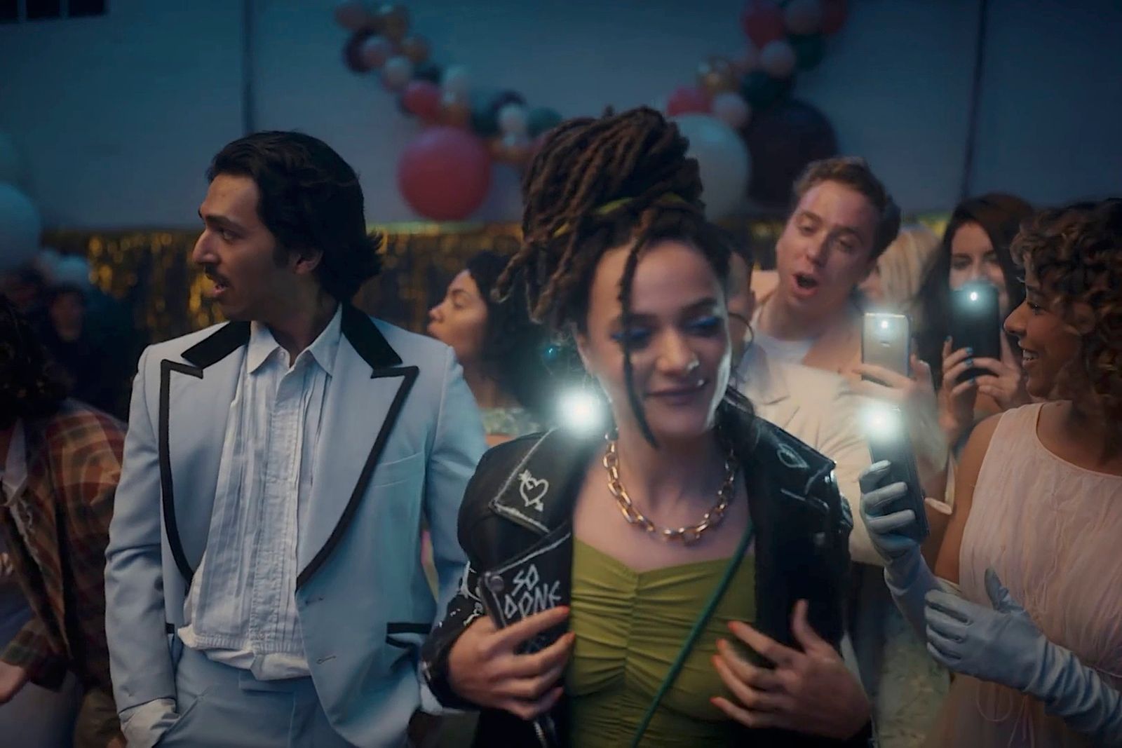 a group of people standing next to each other holding cell phones