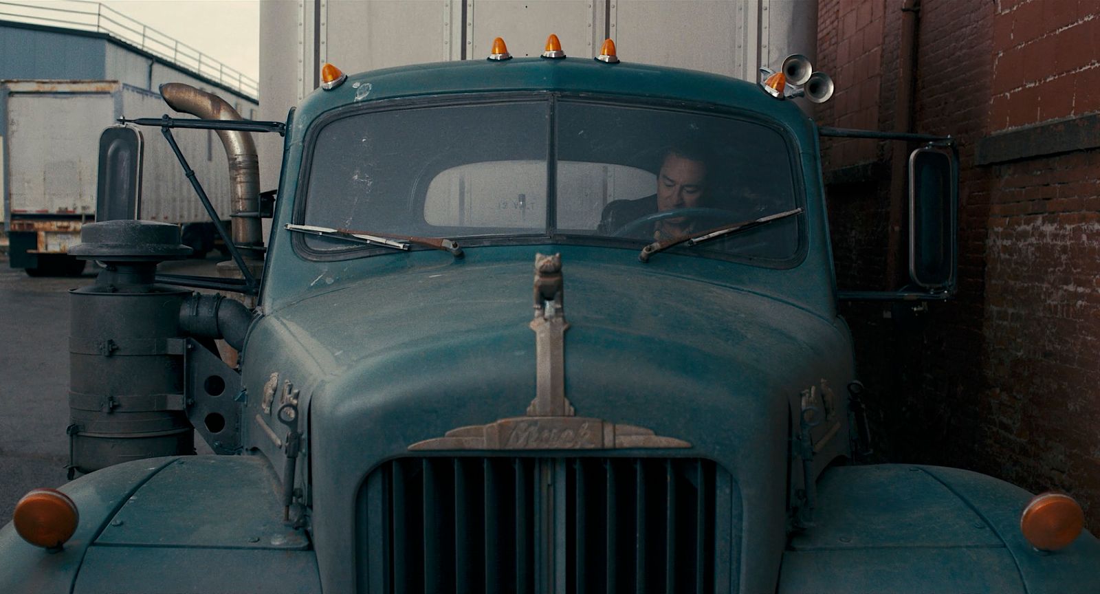 a man sitting in the driver's seat of a truck