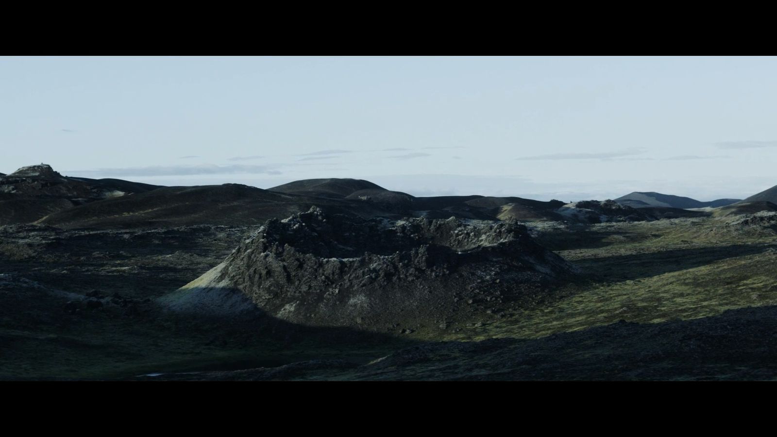 a group of hills with a sky in the background