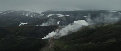 a view of a mountain with steam coming out of it