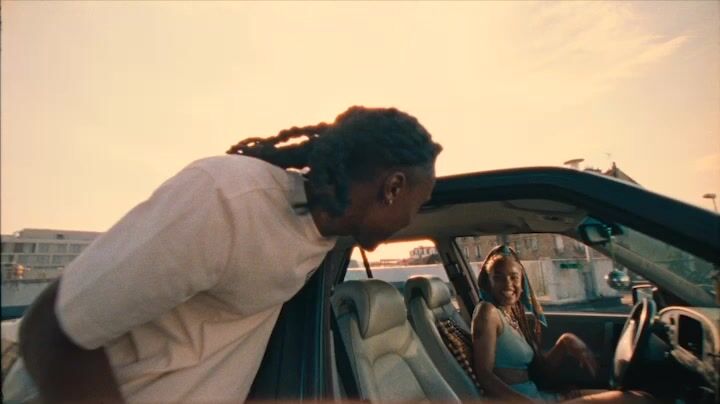 a man with dreadlocks sitting in a car