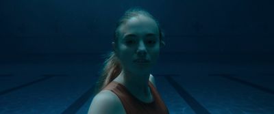 a woman in a tank top standing under water