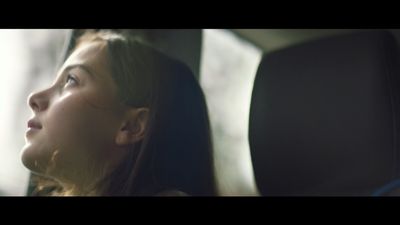 a woman sitting in a car looking out the window