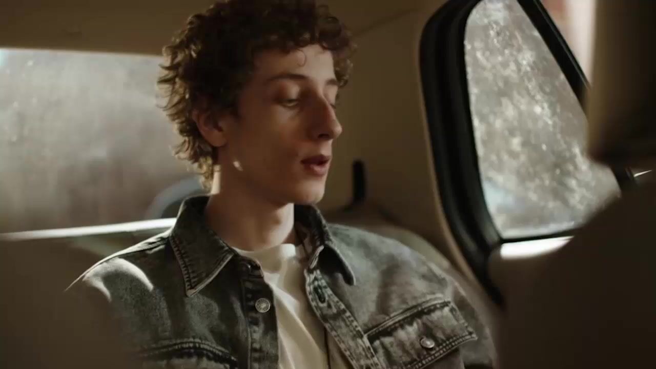 a woman sitting in the back seat of a car