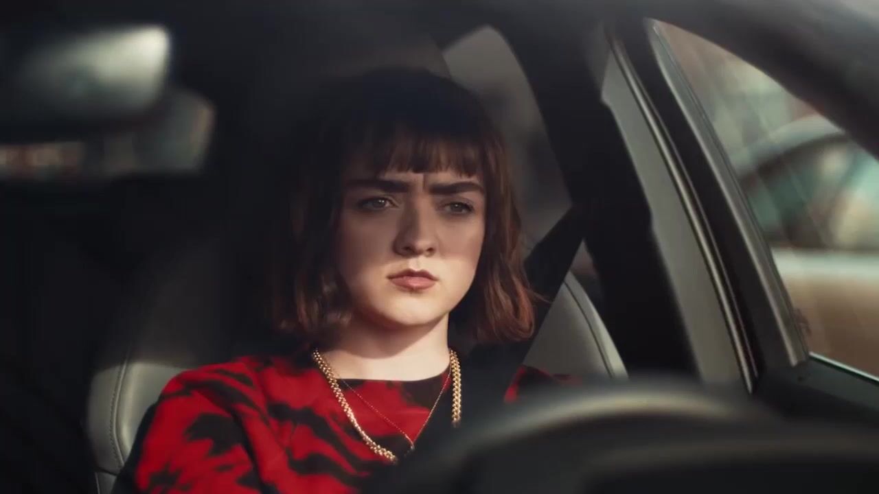 a woman sitting in a car looking out the window