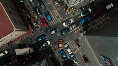 an aerial view of a city street filled with cars