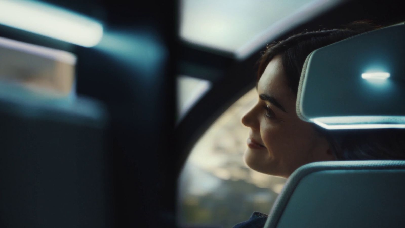 a woman sitting in a car looking out the window