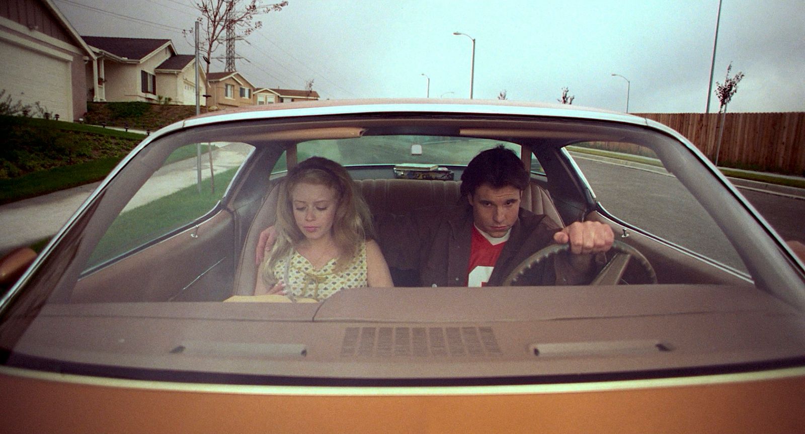 a man and a little girl sitting in a car