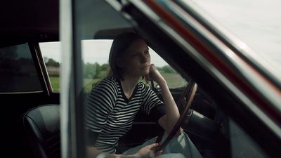 a woman sitting in the passenger seat of a car