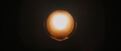 a close up of a light bulb in the dark