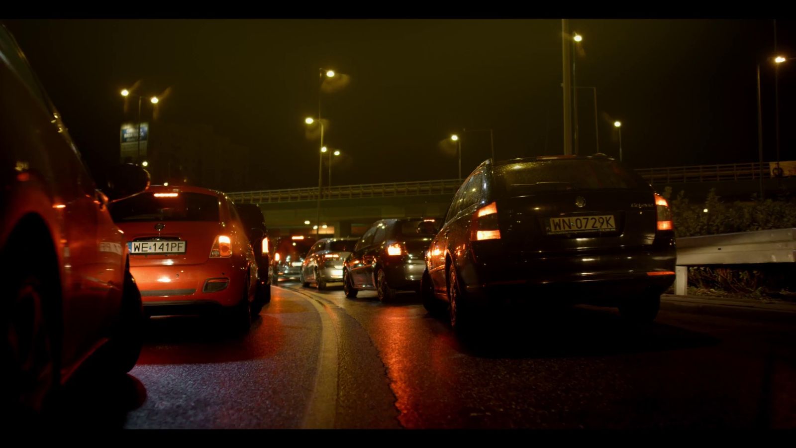 a street filled with lots of traffic at night