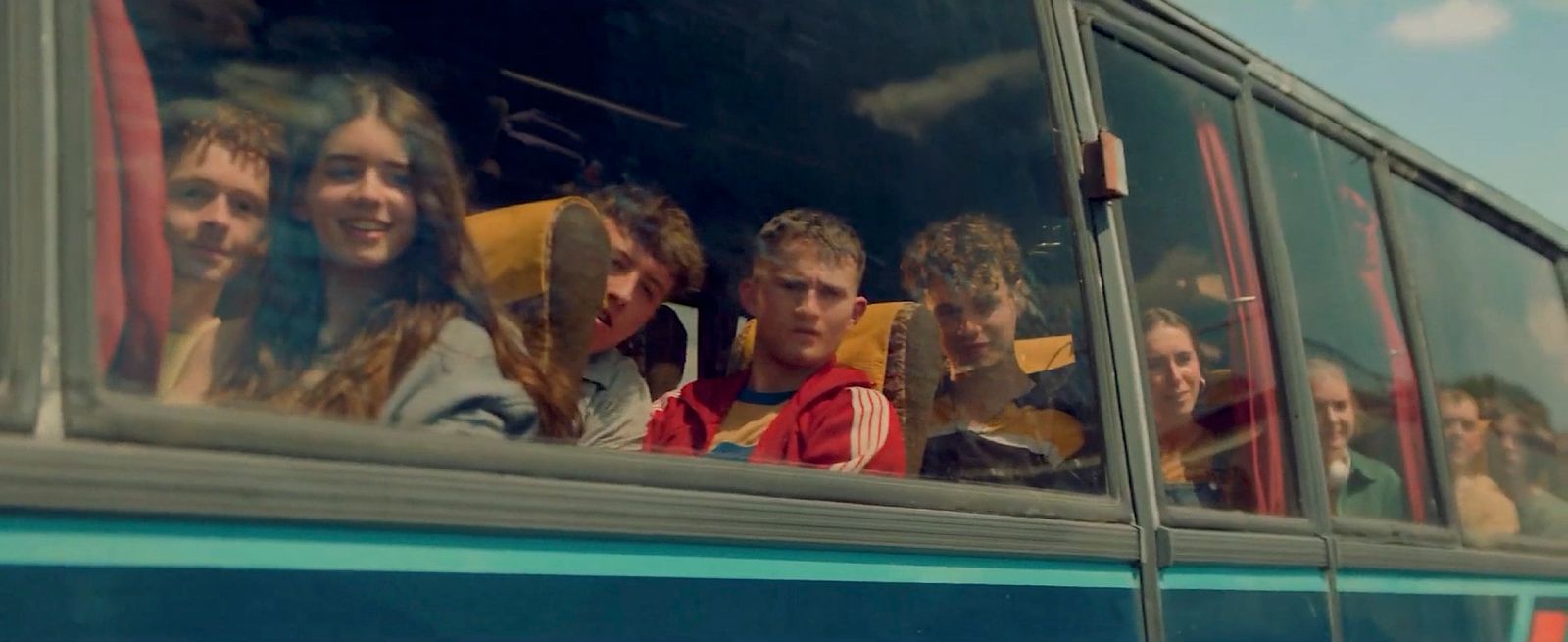 a group of people riding on the back of a bus