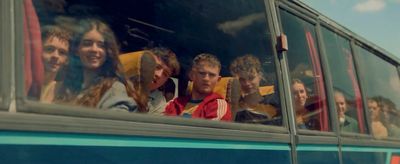 a group of people riding on the back of a bus