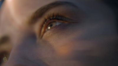 a close up of a person's eye with a blurry background