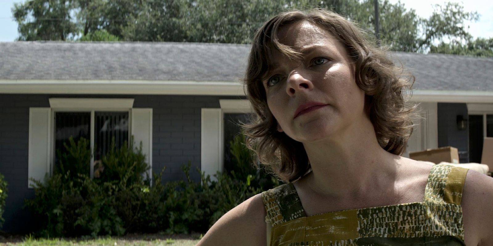 a woman standing in front of a house