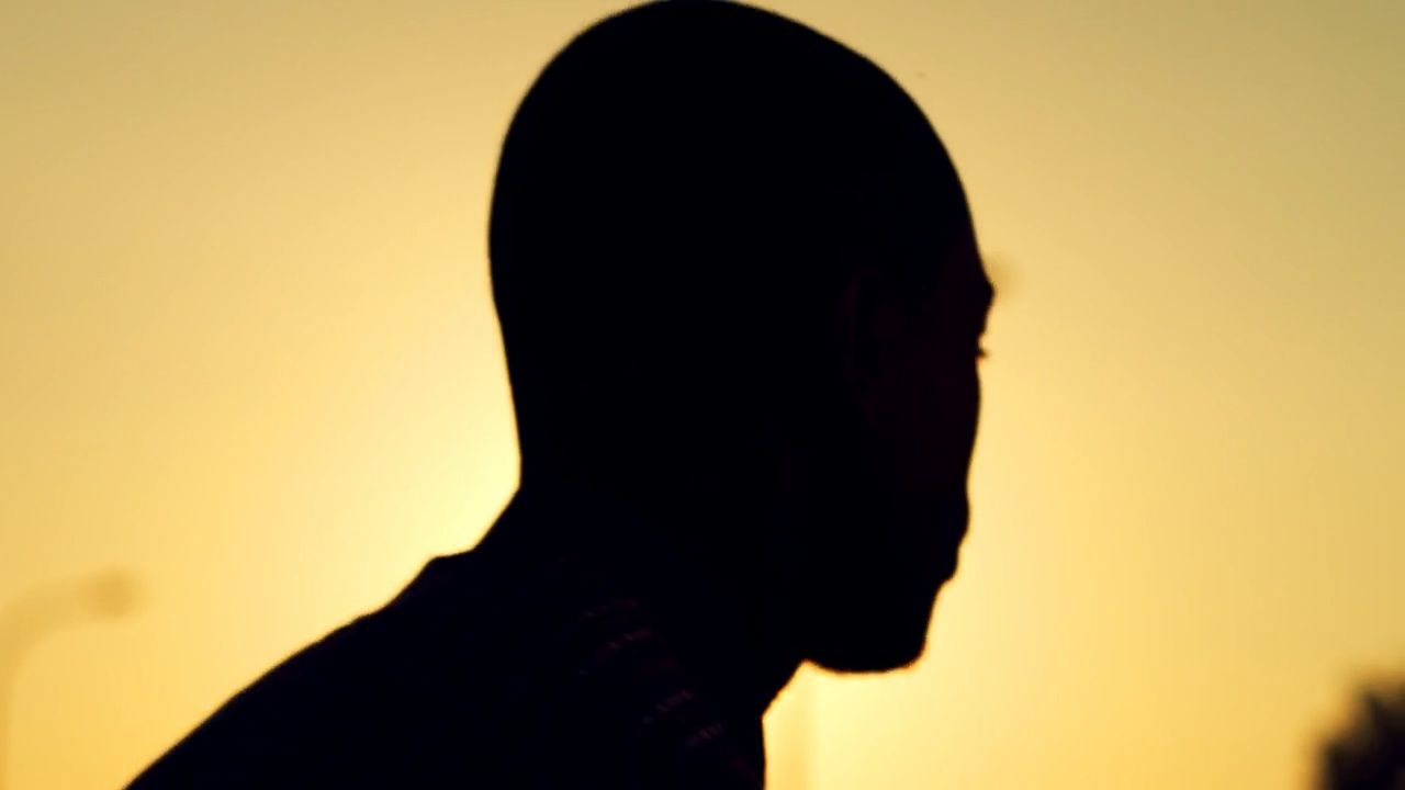 a silhouette of a man holding a cell phone