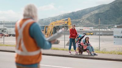 a group of people standing on the side of a road