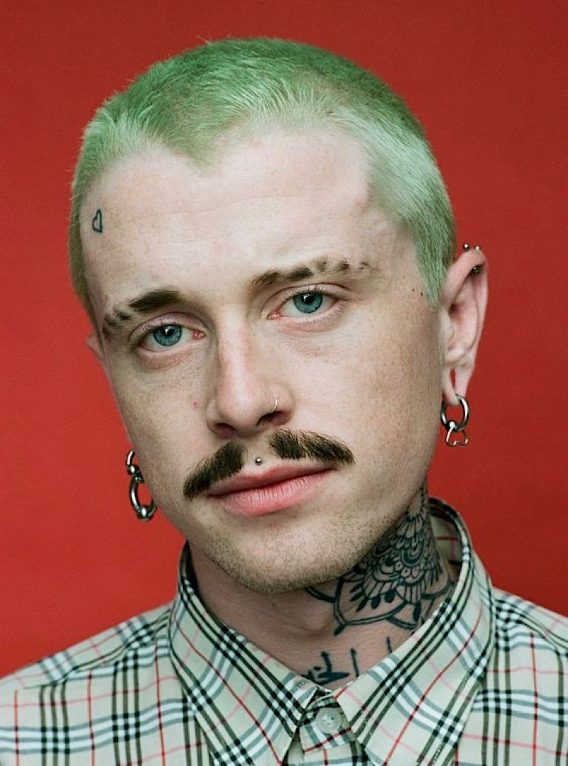 a man with green hair and a moustache