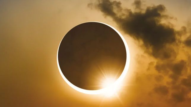 a solar eclipse is seen through the clouds