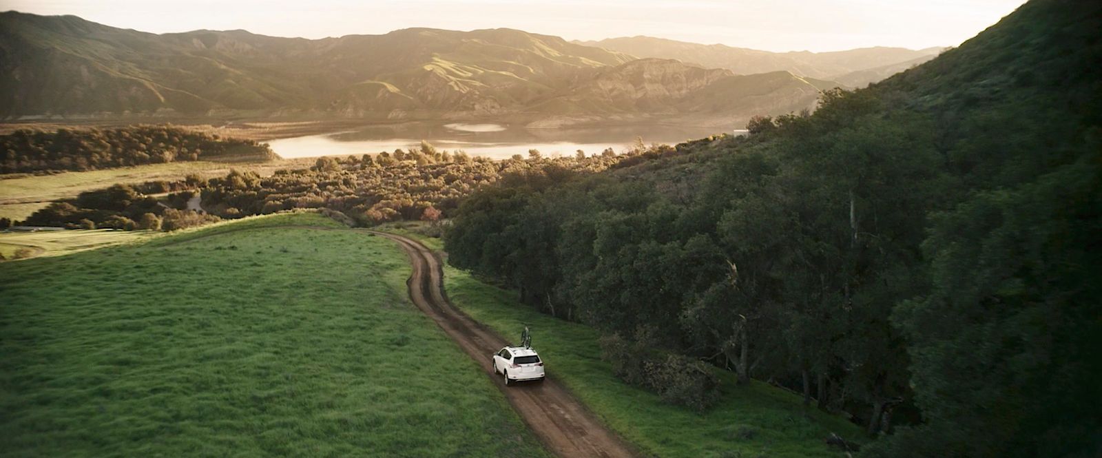 a truck is driving down a dirt road