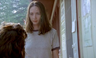 a woman standing in front of a door talking to another woman