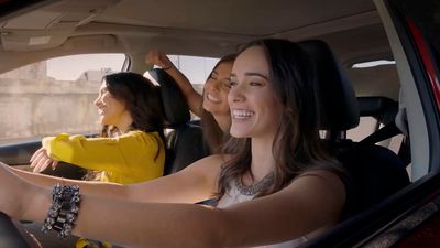 a group of women sitting in the back of a car