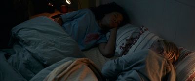 a person sleeping in a bed with a light on