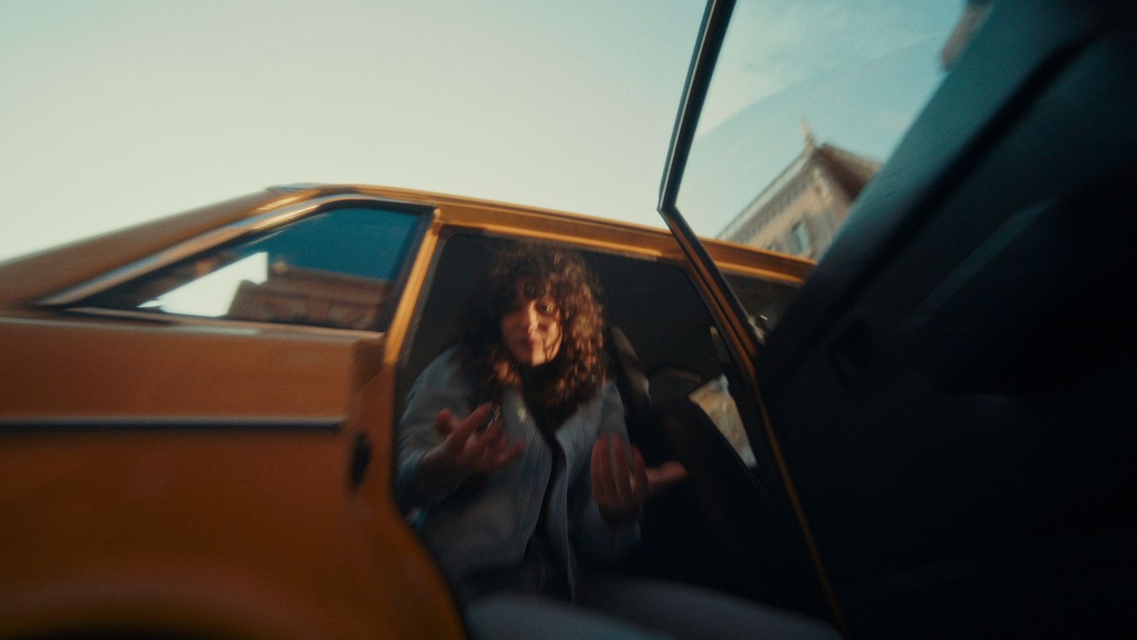 a woman sitting in the driver's seat of a car