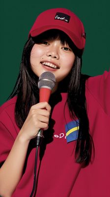 a woman in a red shirt holding a microphone