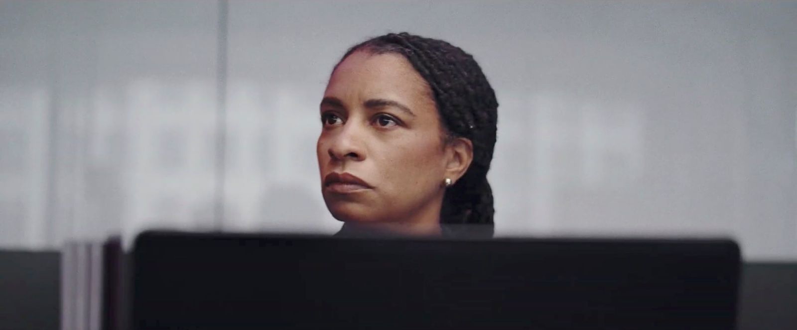 a woman with braids looking at the camera