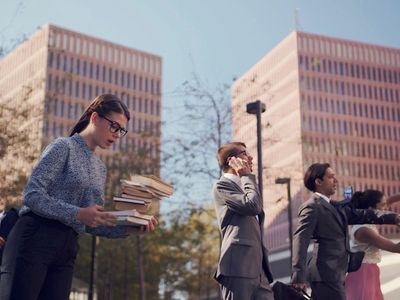 a group of people standing in front of tall buildings