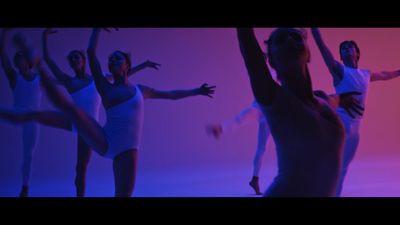 a group of women in white leotards are dancing