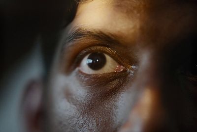 a close up of a man's eye with a blurry background