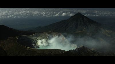 a view of a mountain with steam coming out of it