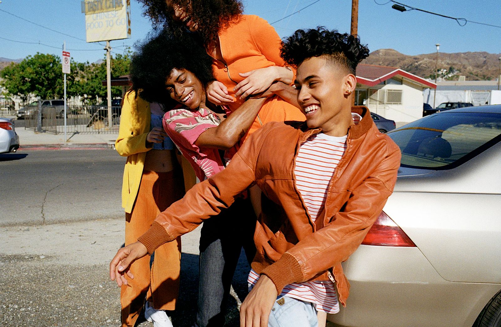 a group of people standing next to a car