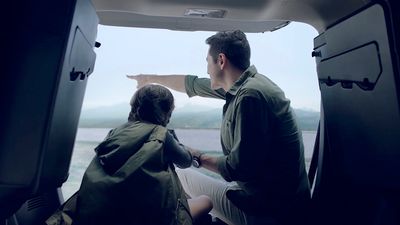 a man and a woman sitting in the back of a van