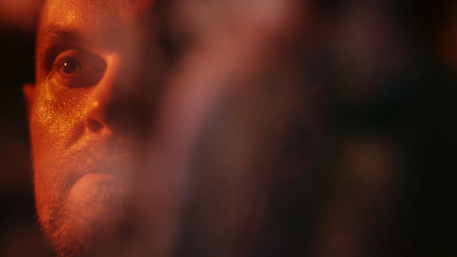 a close up of a man's face with a blurry background