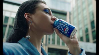 a woman is drinking a can of soda