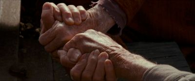 an older person holding the hand of a younger person