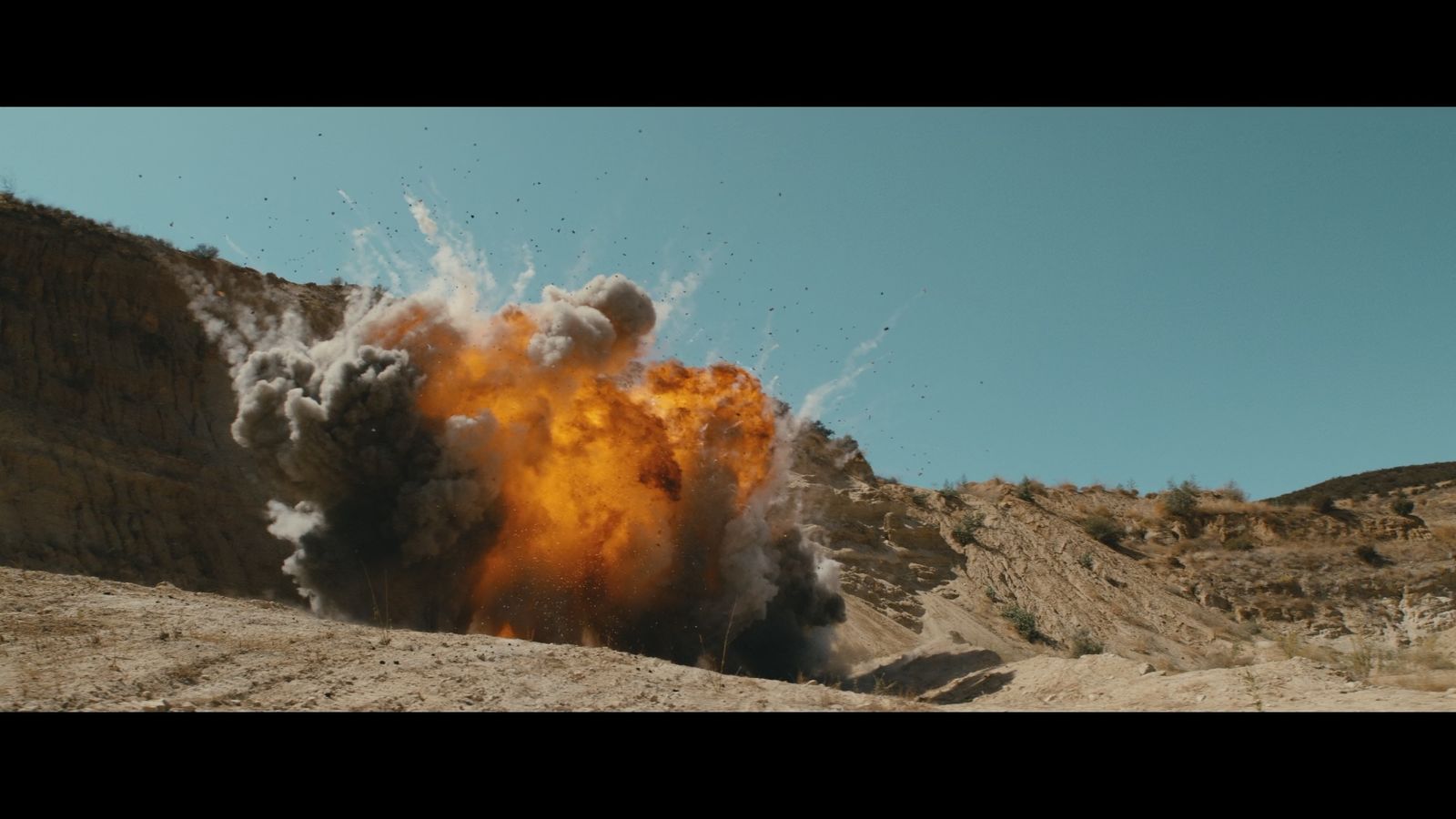 a huge explosion of smoke and dirt in the desert