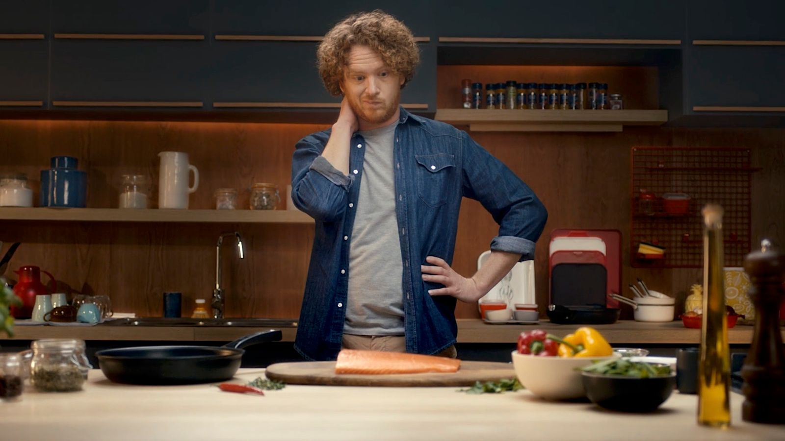 a man standing in a kitchen next to a counter