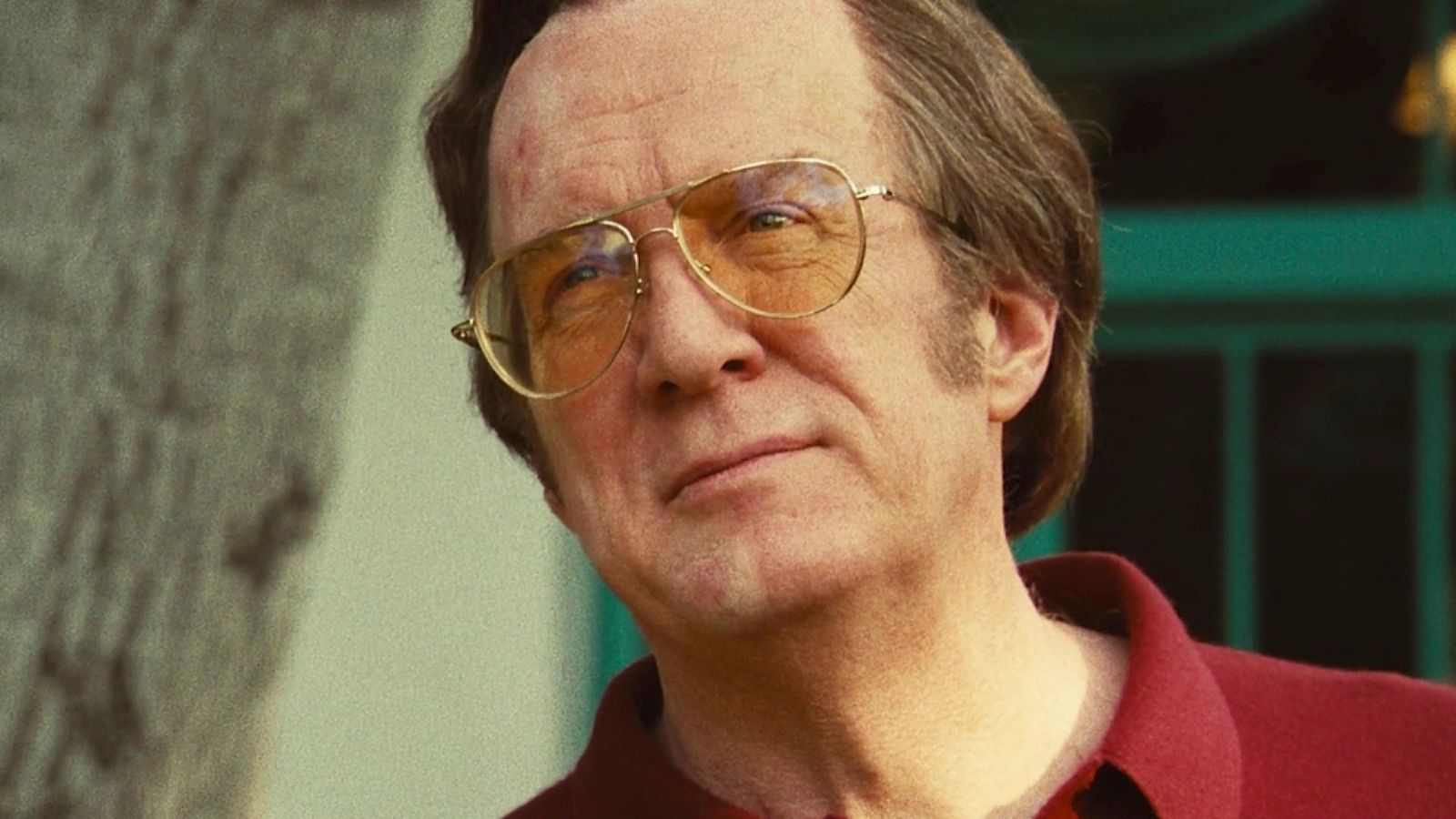 a man wearing glasses and a red shirt