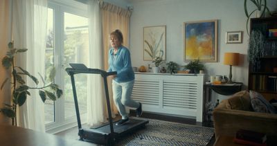 a woman on a treadmill in a living room