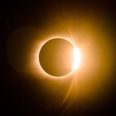 a solar eclipse is seen in the dark sky