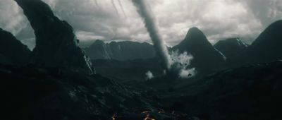 a group of people standing on top of a mountain under a cloudy sky